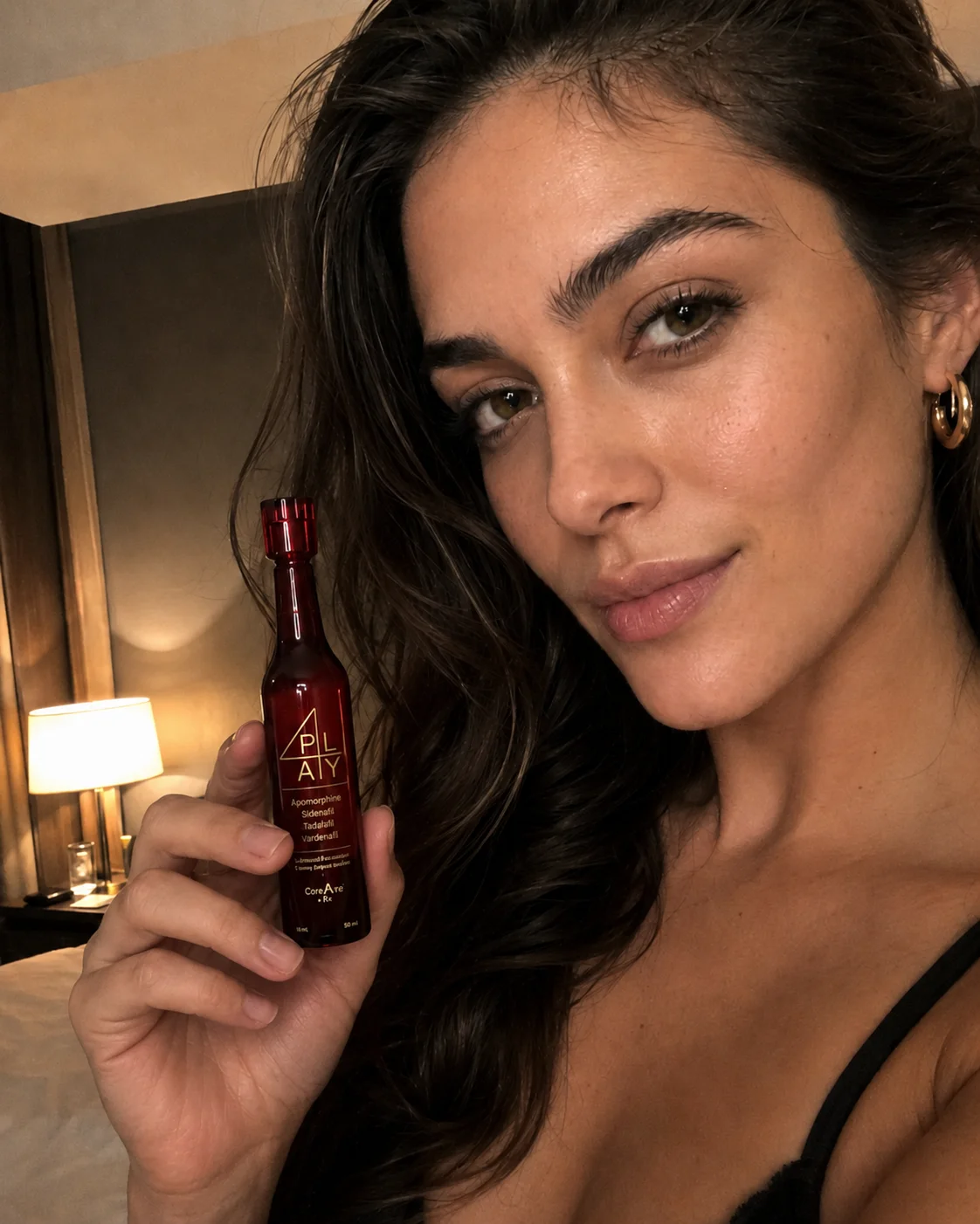 A woman holding a bottle of 4PLAY sublingual formula in a warmly lit bedroom